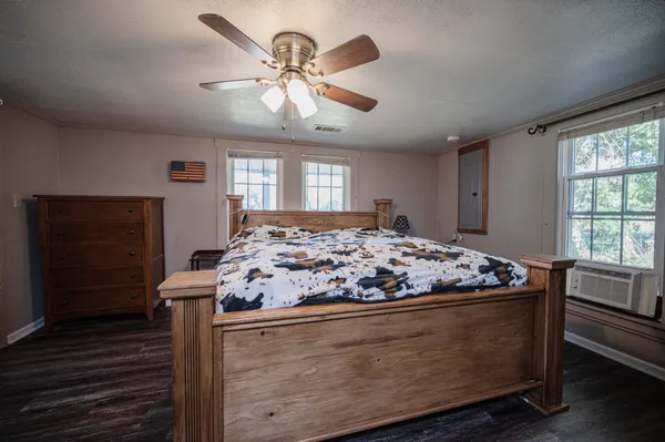 a bedroom with furniture and wooden floor