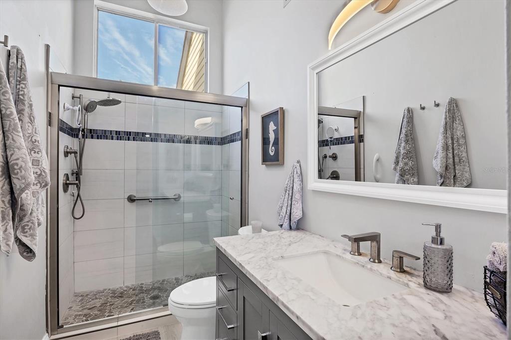 680 White Pine Tree Road, Unit 61 Venice, FL 34285 - Photo 11 of 40 a bathroom with a granite countertop sink a toilet and shower