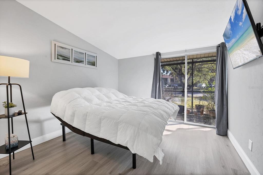 680 White Pine Tree Road, Unit 61 Venice, FL 34285 - Photo 12 of 40 a bedroom with a bed and a large window