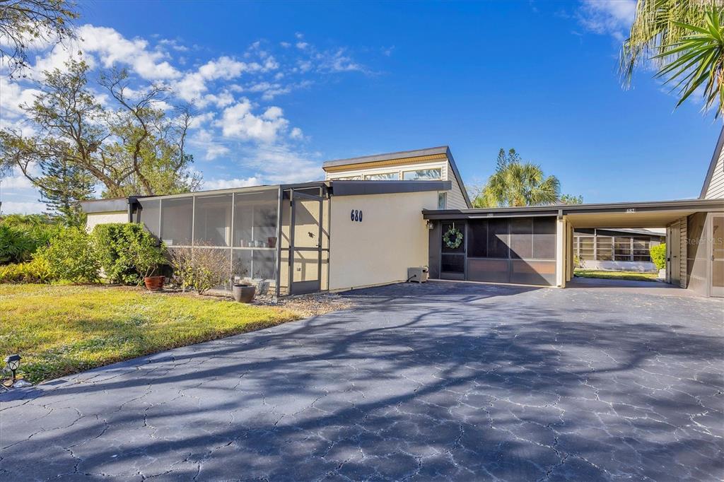 680 White Pine Tree Road, Unit 61 Venice, FL 34285 - Photo 21 of 40 a front view of a house with a yard and garage