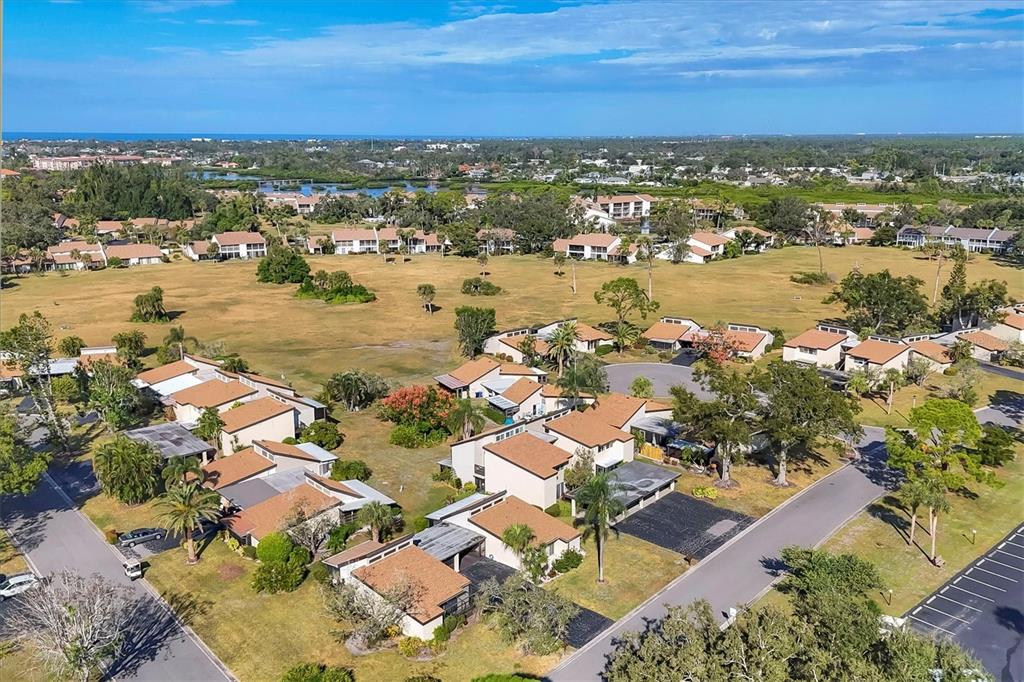 680 White Pine Tree Road, Unit 61 Venice, FL 34285 - Photo 25 of 40 an aerial view of residential houses with outdoor space