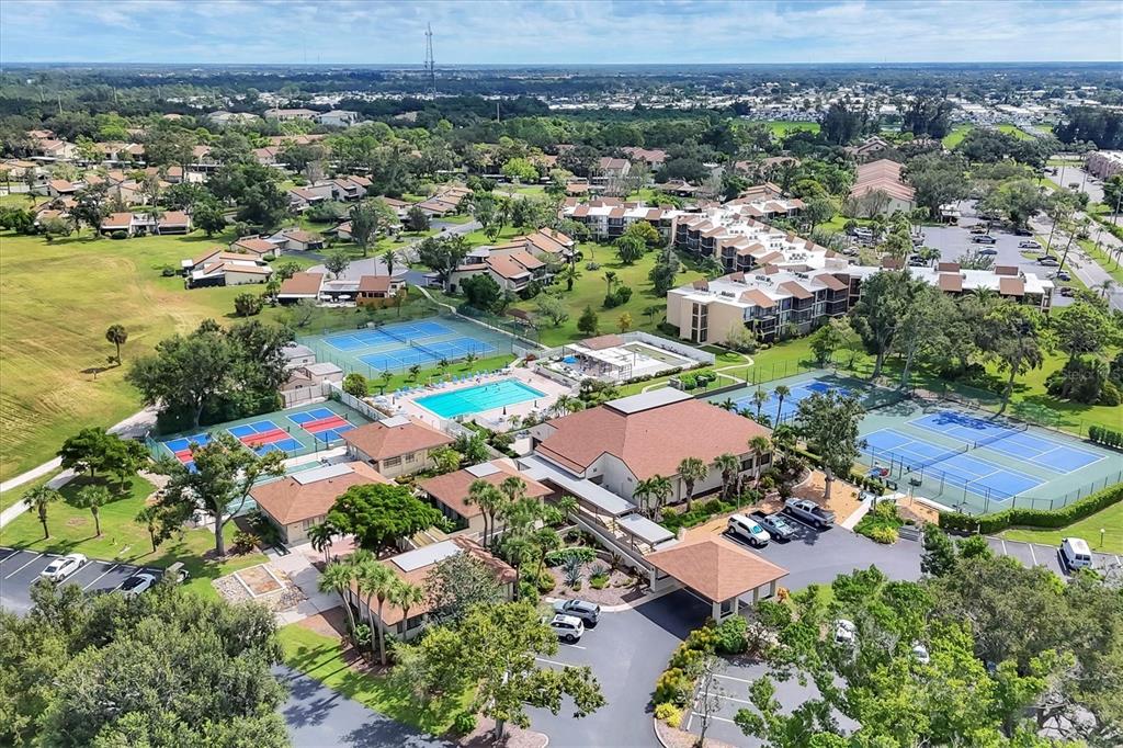 680 White Pine Tree Road, Unit 61 Venice, FL 34285 - Photo 28 of 40 an aerial view of residential houses with outdoor space and trees