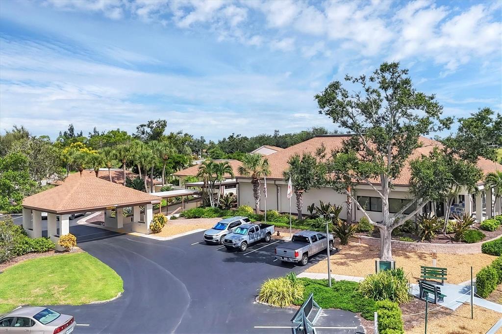 680 White Pine Tree Road, Unit 61 Venice, FL 34285 - Photo 29 of 40 a view of a swimming pool with lawn chairs under an umbrella