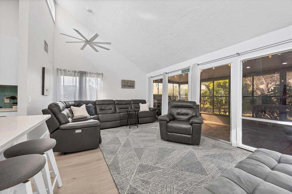680 White Pine Tree Road, Unit 61 Venice, FL 34285 - Photo 3 of 40 a living room with furniture and a large window
