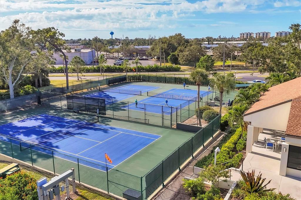 680 White Pine Tree Road, Unit 61 Venice, FL 34285 - Photo 36 of 40 a view of a tennis ground with large trees