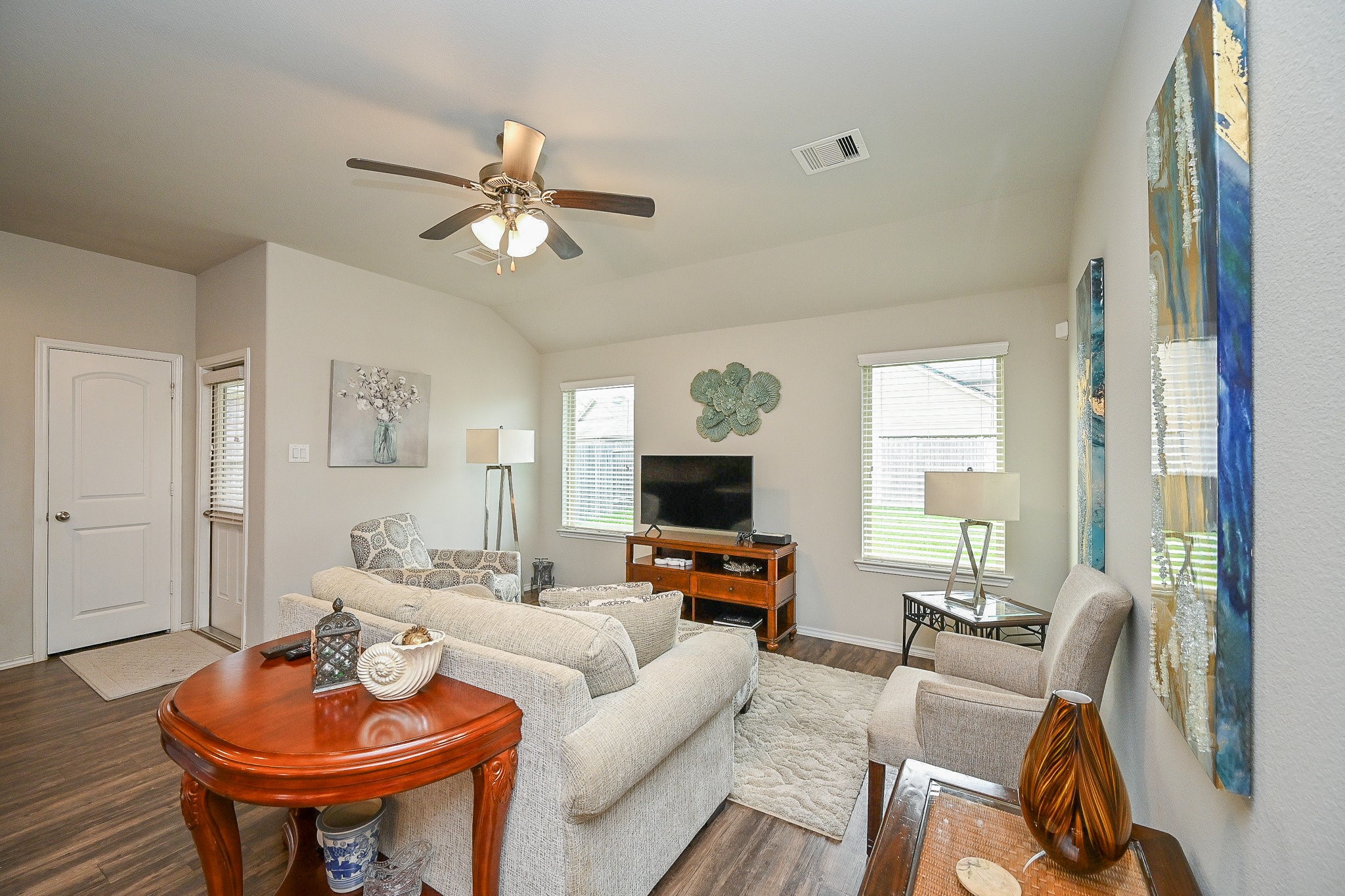 15418 Lost Lariat Court Channelview, TX 77530 - Photo 12 of 20 a living room with furniture a fireplace and a chandelier