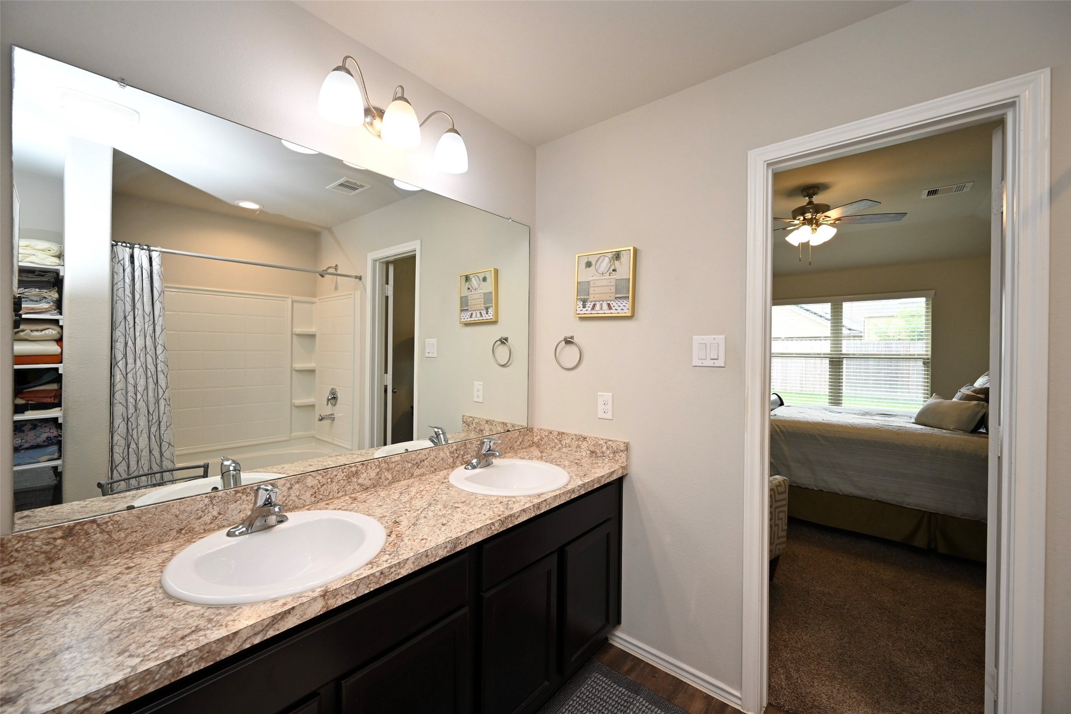 15418 Lost Lariat Court Channelview, TX 77530 - Photo 16 of 20 a bathroom with a granite countertop sink and a mirror