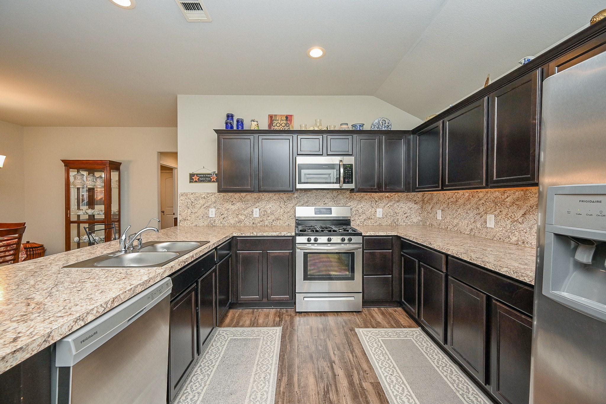 15418 Lost Lariat Court Channelview, TX 77530 - Photo 9 of 20 a kitchen with stainless steel appliances granite countertop a sink stove and refrigerator