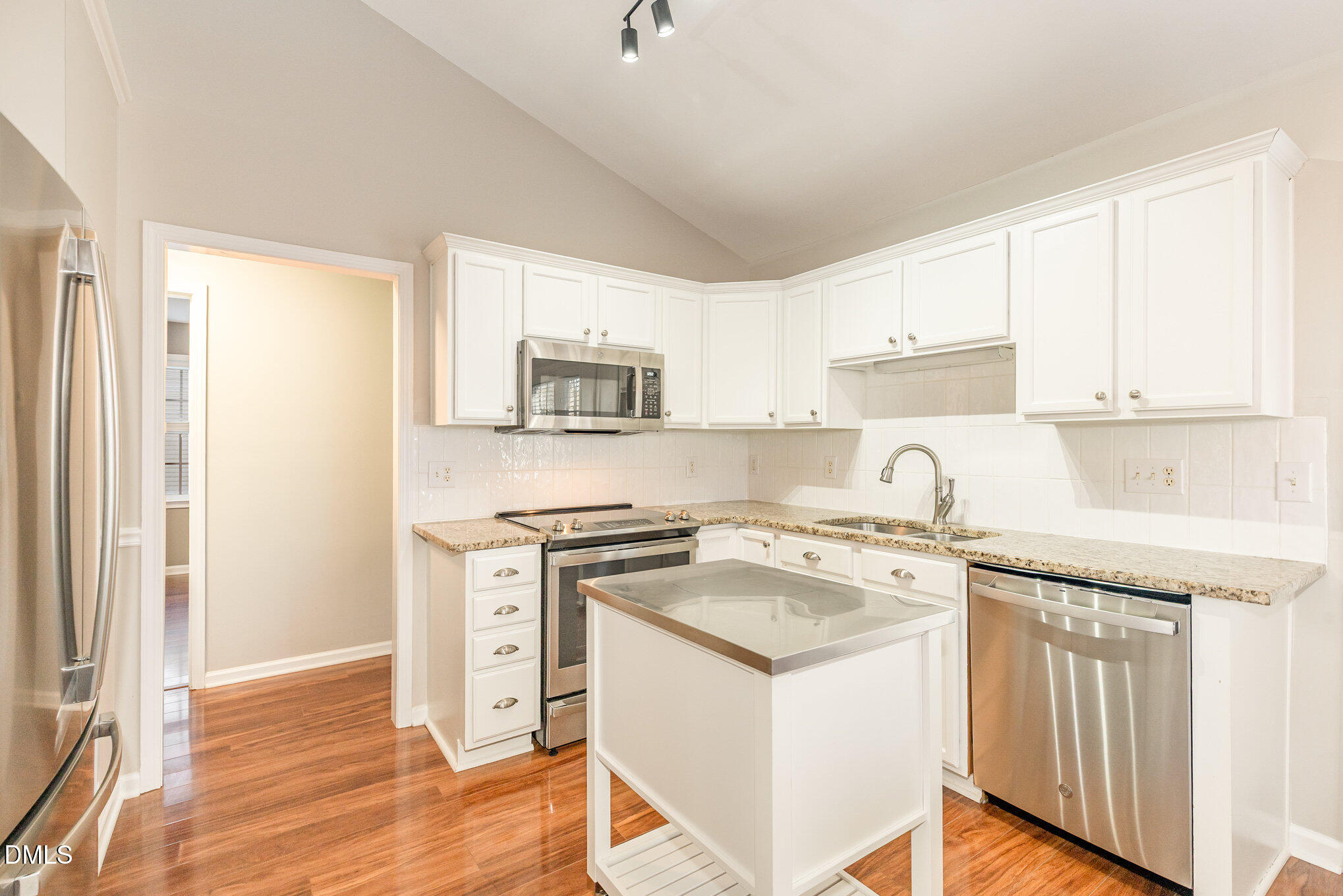 2813 Glastonbury Road Apex, NC 27539 - Photo 10 of 21 a kitchen with a stove a sink and a refrigerator