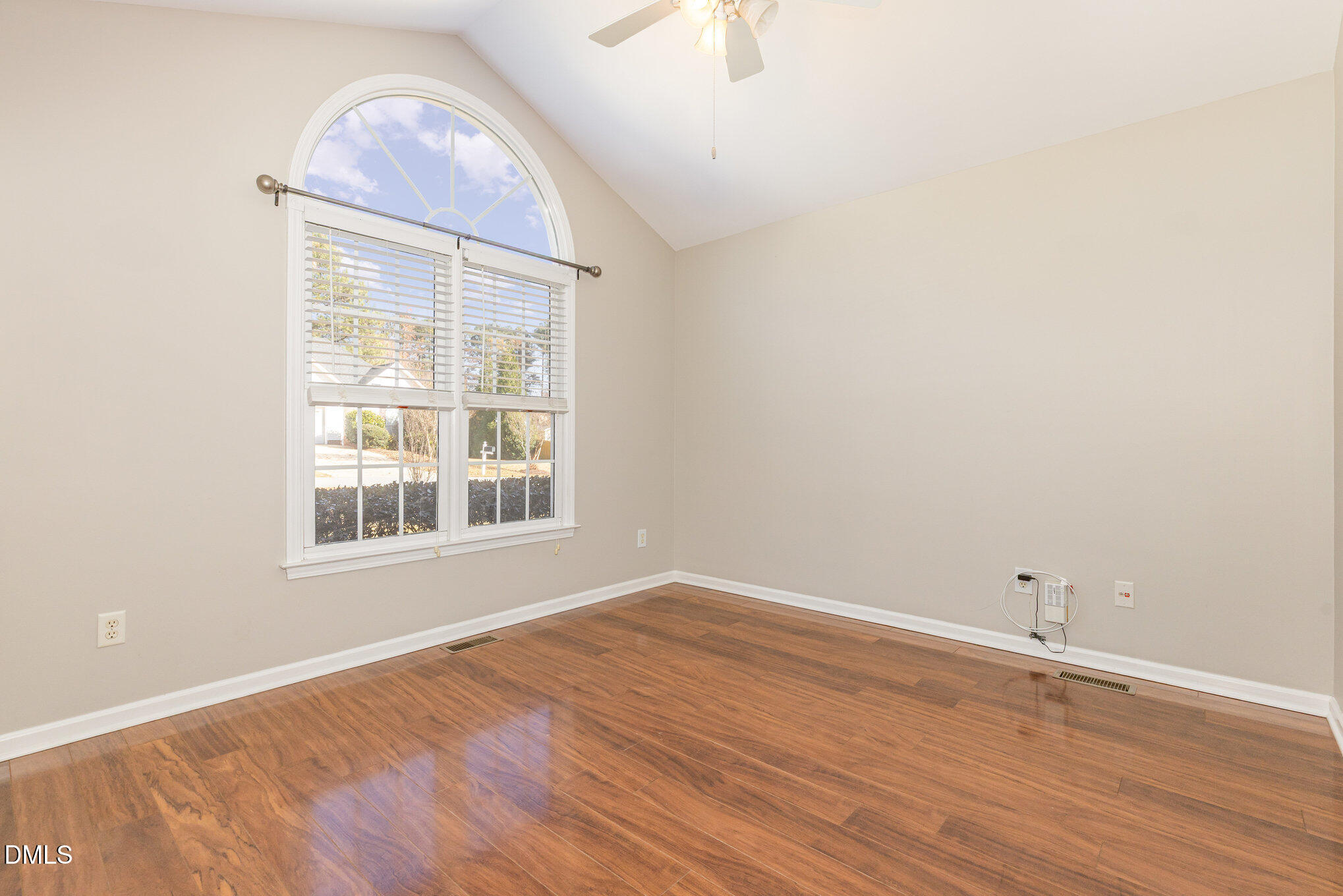 2813 Glastonbury Road Apex, NC 27539 - Photo 11 of 21 an empty room with wooden floor and windows