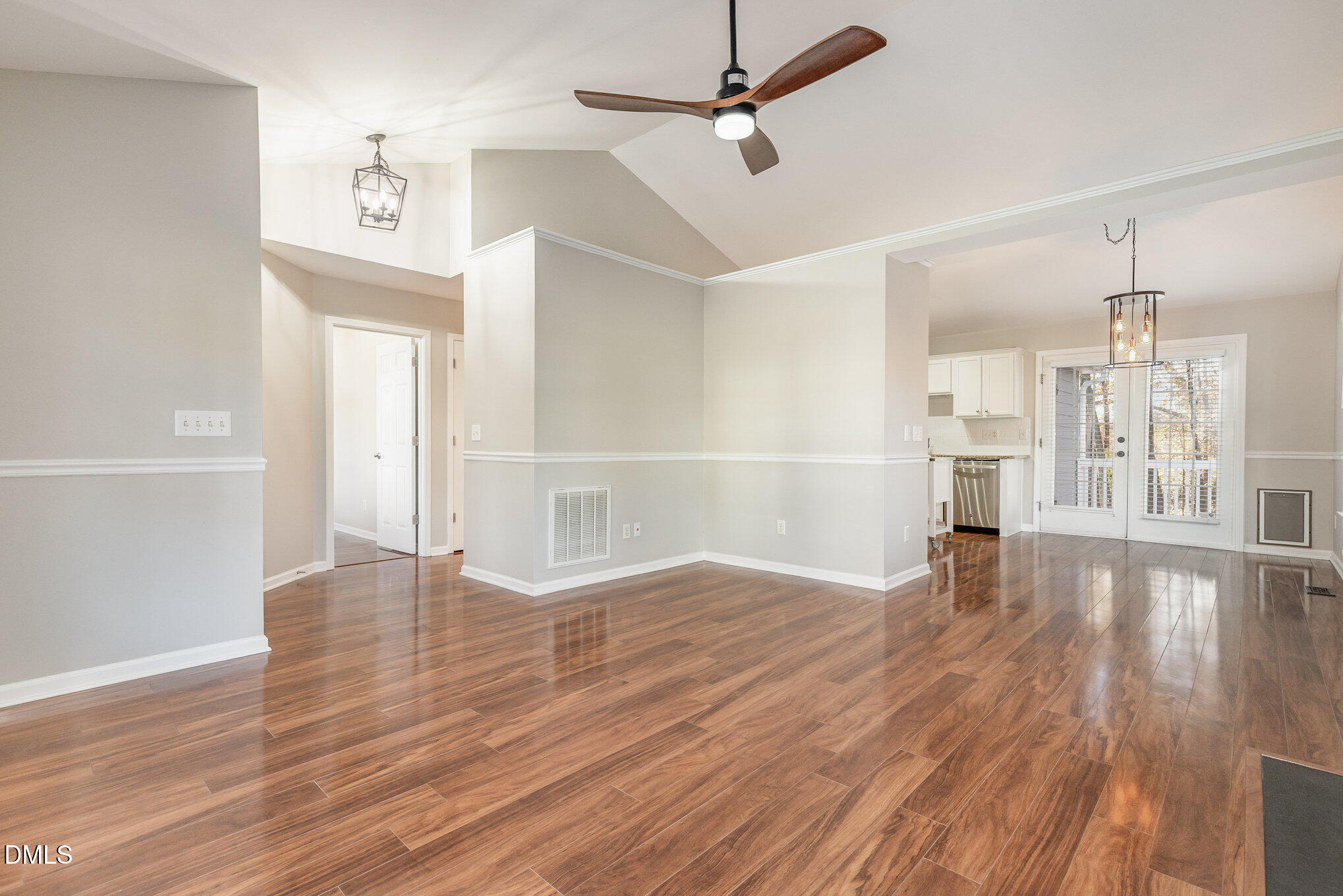2813 Glastonbury Road Apex, NC 27539 - Photo 5 of 21 a view of an empty room with wooden floor and a window