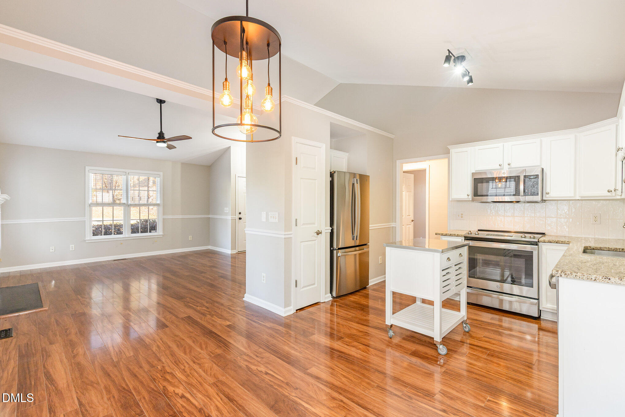 2813 Glastonbury Road Apex, NC 27539 - Photo 7 of 21 a kitchen with stainless steel appliances a stove a refrigerator cabinets and wooden floor