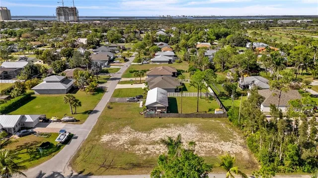 an aerial view of residential houses with yard