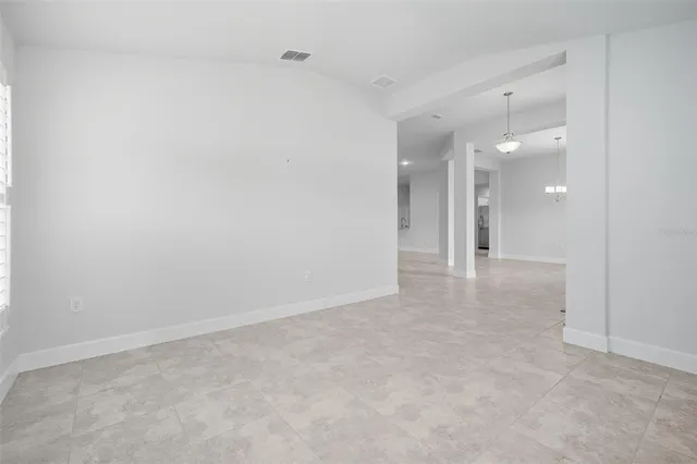 a view of a dining room with furniture and window