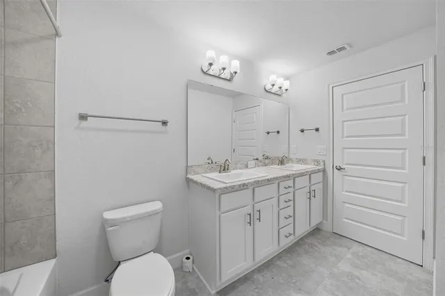 a bathroom with a tub sink and vanity
