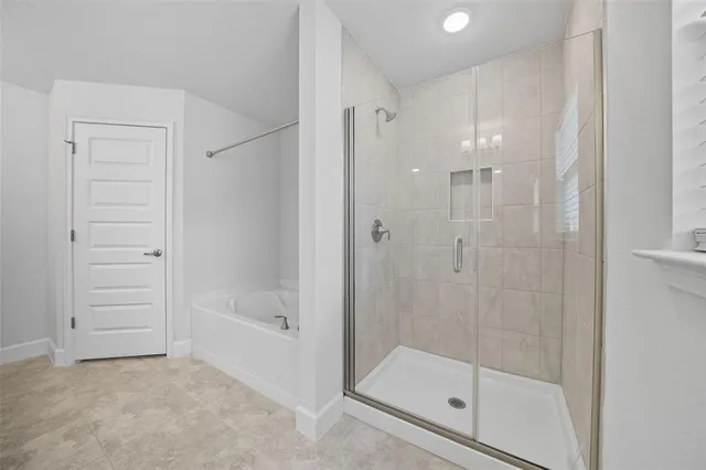 an empty room with a window and ceiling fan