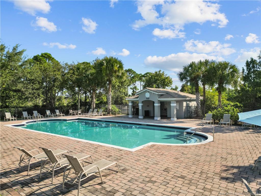 1268 Southeast Kirk Street Stuart, FL 34997 - Photo 5 of 63 a view of a house with swimming pool and a yard