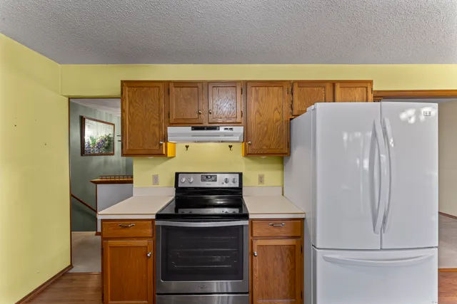 a kitchen with a refrigerator and a stove