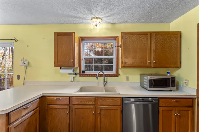 a kitchen with stainless steel appliances a sink a stove and a microwave