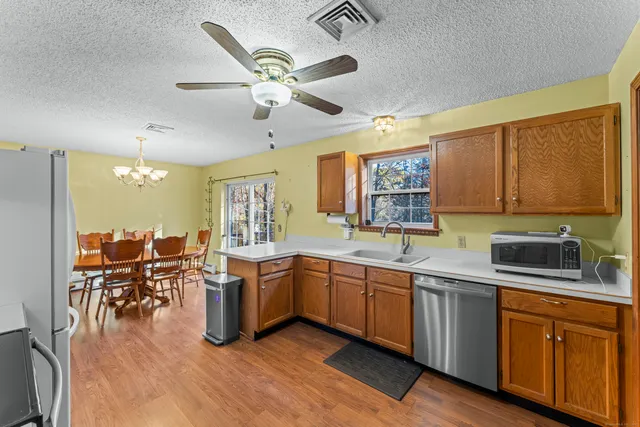 a open kitchen with stainless steel appliances granite countertop lots of counter top space and furniture