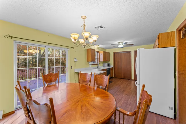 a view of a dining room with furniture a chandelier and wooden floor