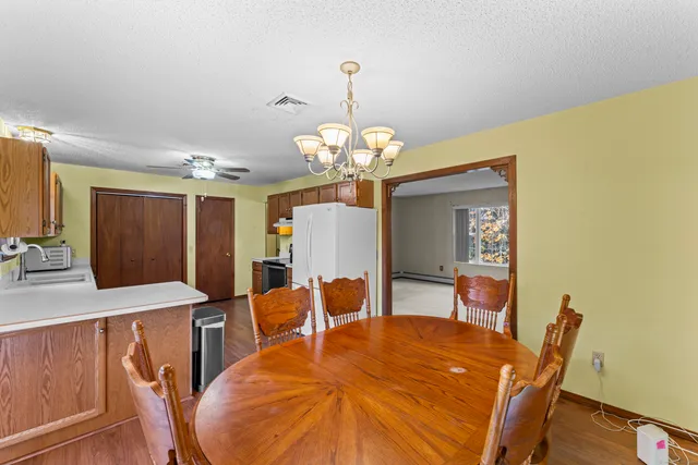 a dining room with a table chairs and a chandelier