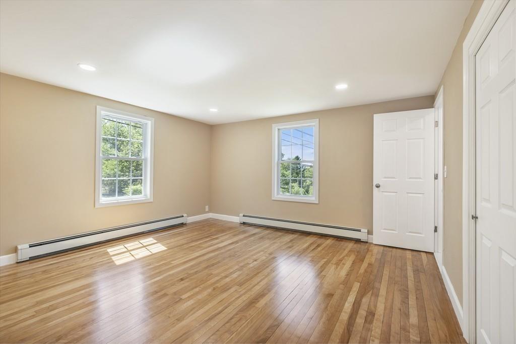 333 Berlin Road Marlborough, MA 01752 - Photo 16 of 32 an empty room with wooden floor and windows