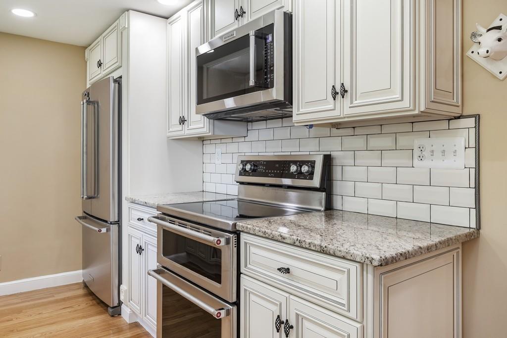 333 Berlin Road Marlborough, MA 01752 - Photo 4 of 32 a kitchen with stainless steel appliances granite countertop a stove microwave and refrigerator