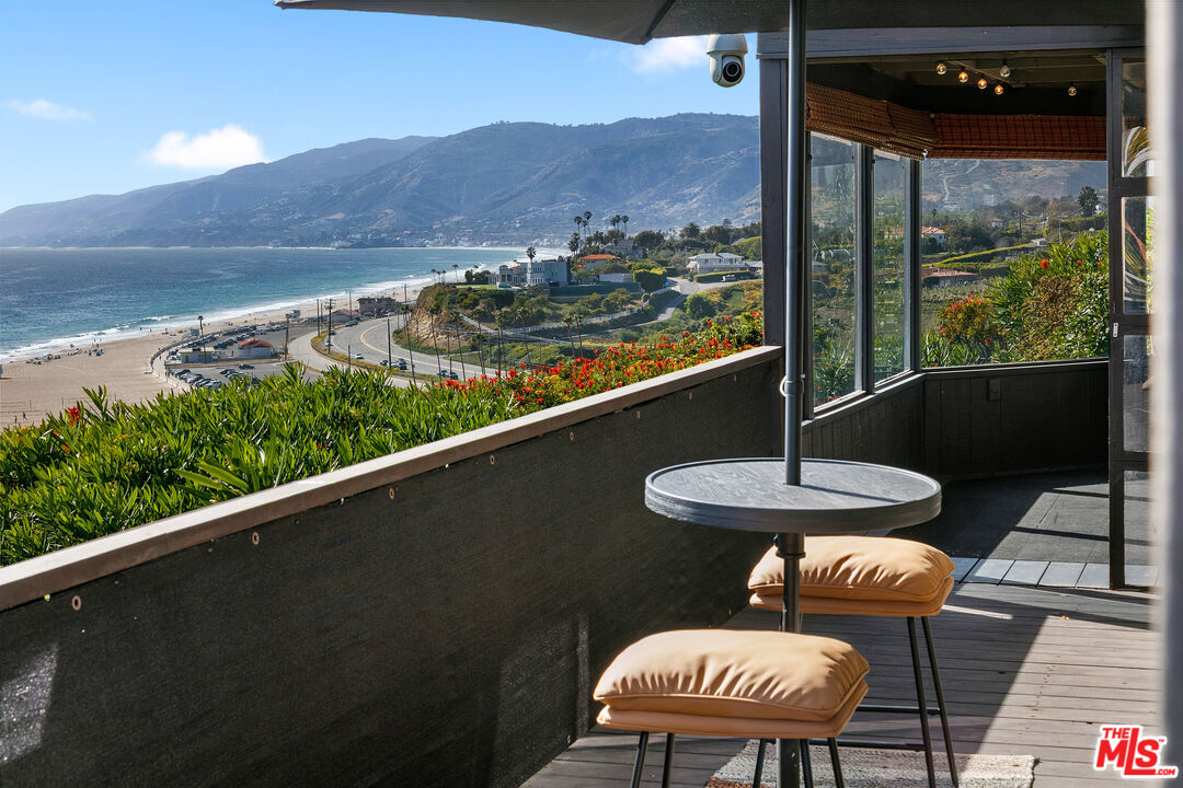 29500 Heathercliff Road, Unit 159 Malibu, CA 90265 - Photo 1 of 37 a view of a balcony with table and chairs