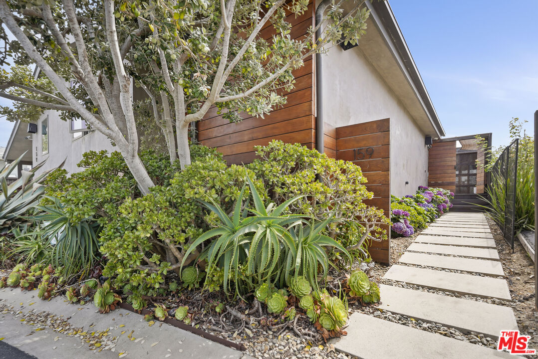 29500 Heathercliff Road, Unit 159 Malibu, CA 90265 - Photo 2 of 37 a view of a garden with pathway