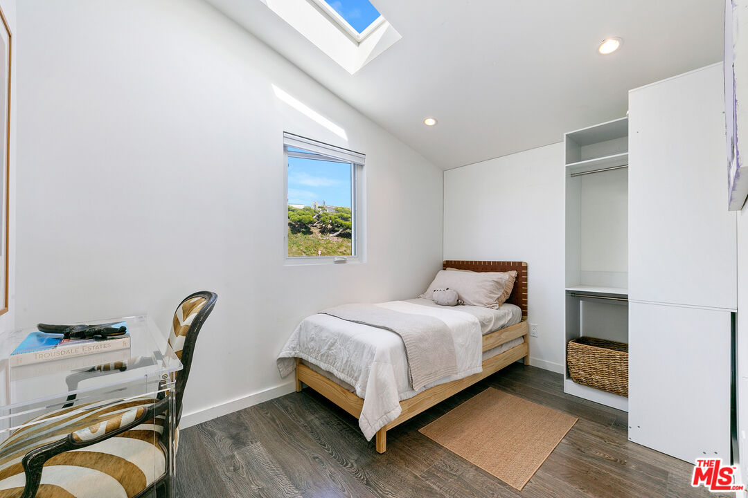 29500 Heathercliff Road, Unit 159 Malibu, CA 90265 - Photo 23 of 37 a bed room with a bed and a chair