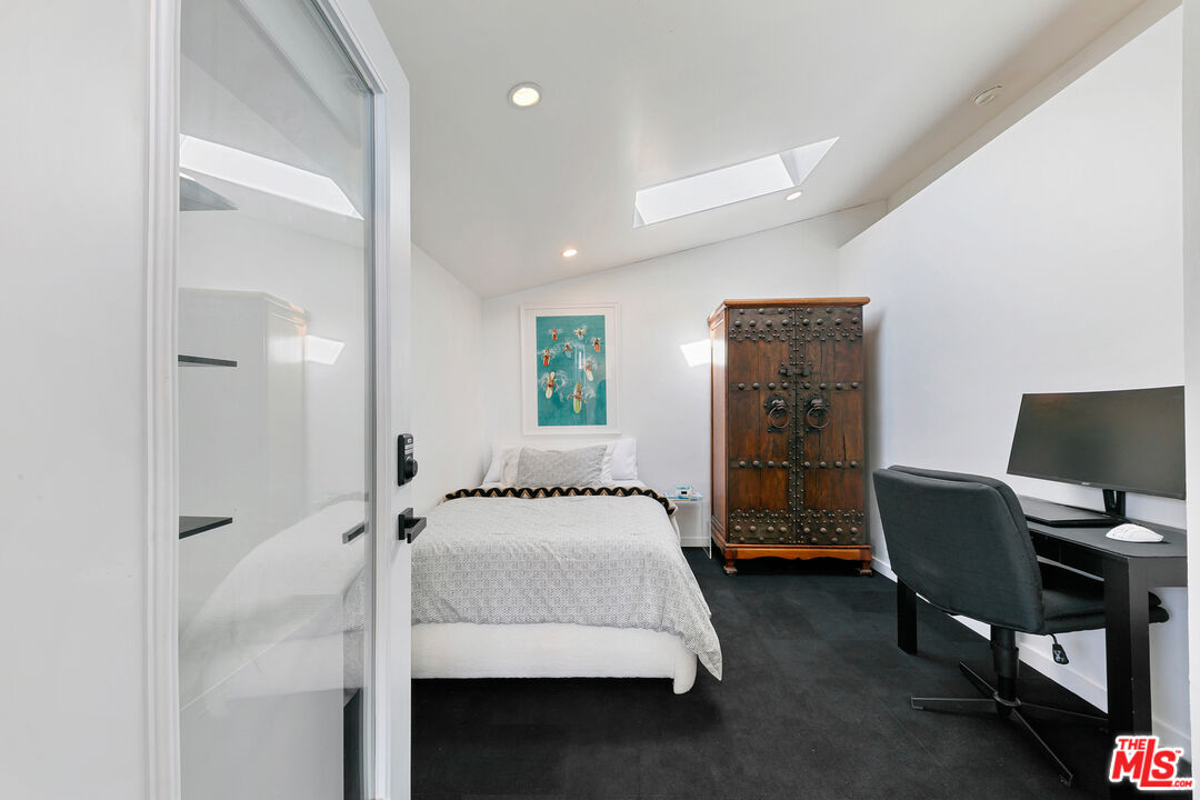 29500 Heathercliff Road, Unit 159 Malibu, CA 90265 - Photo 27 of 37 a bedroom with a bed and a desk