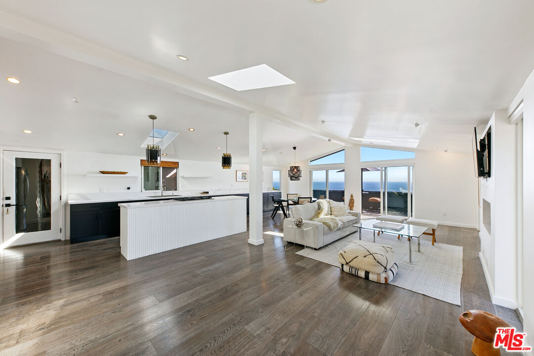 29500 Heathercliff Road, Unit 159 Malibu, CA 90265 - Photo 3 of 37 a large white kitchen with a large window and stainless steel appliances