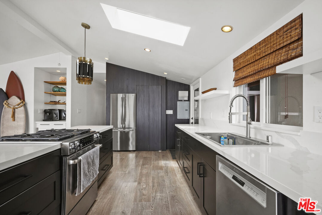 29500 Heathercliff Road, Unit 159 Malibu, CA 90265 - Photo 7 of 37 a kitchen with stainless steel appliances granite countertop a sink and a stove