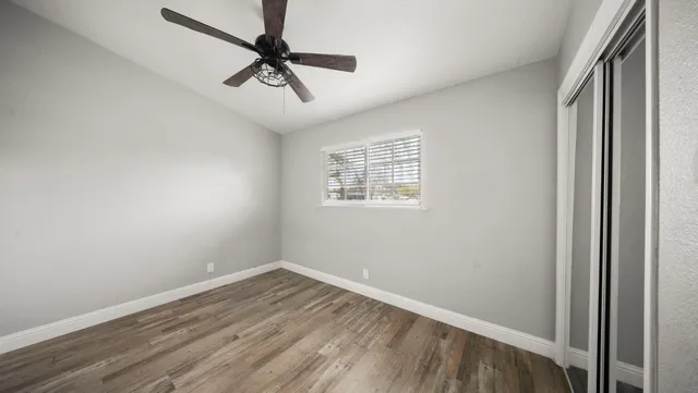wooden floor in an empty room with a window
