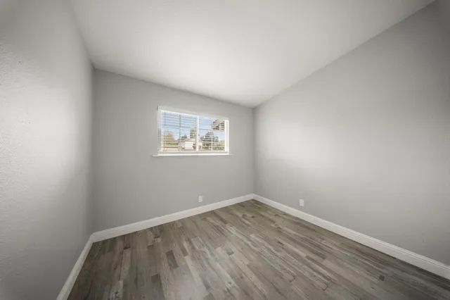 a view of a room with wooden floor