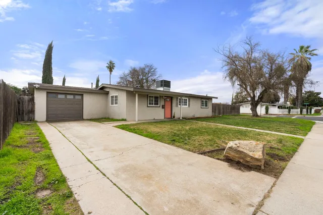 a large kitchen with kitchen island granite countertop a sink a counter top space and stainless steel appliances