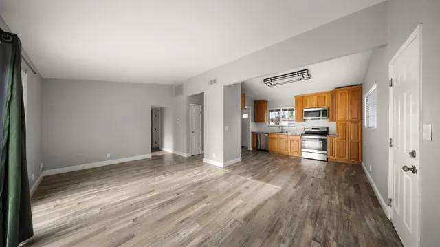 a view of hallway with wooden floor
