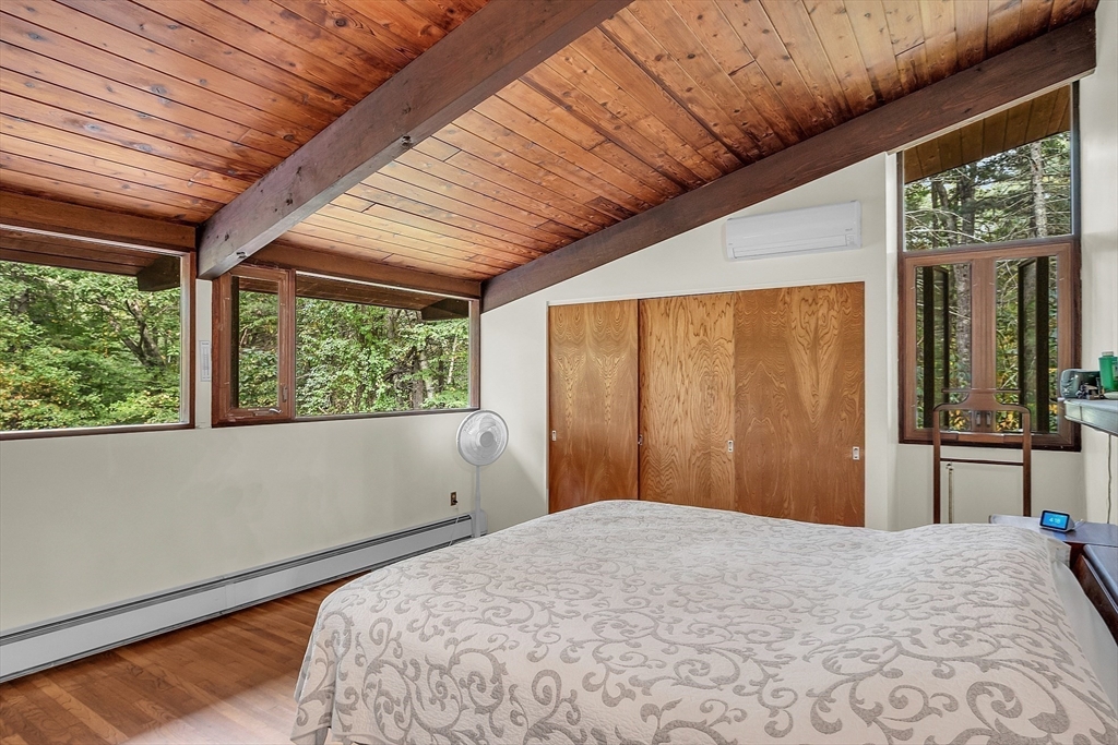 191 Heald Road Carlisle, MA 01741 - Photo 16 of 32 a bedroom with a bed and a large window