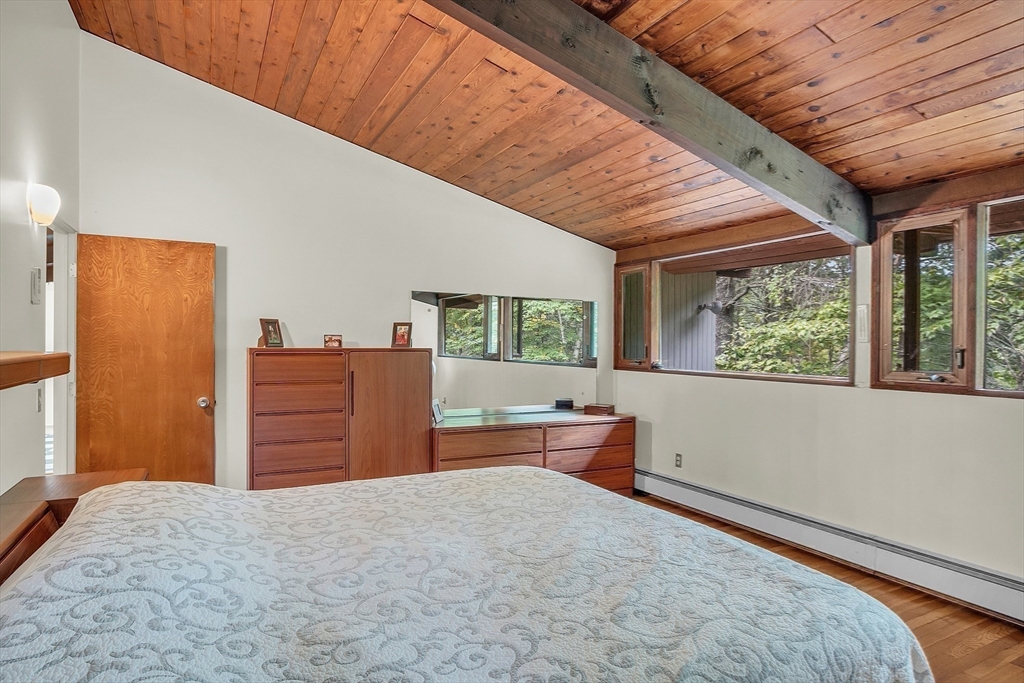 191 Heald Road Carlisle, MA 01741 - Photo 17 of 32 a bed room with a bed and wooden floor