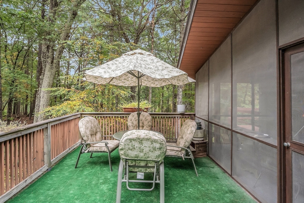 191 Heald Road Carlisle, MA 01741 - Photo 25 of 32 a view of a chair and table on the deck