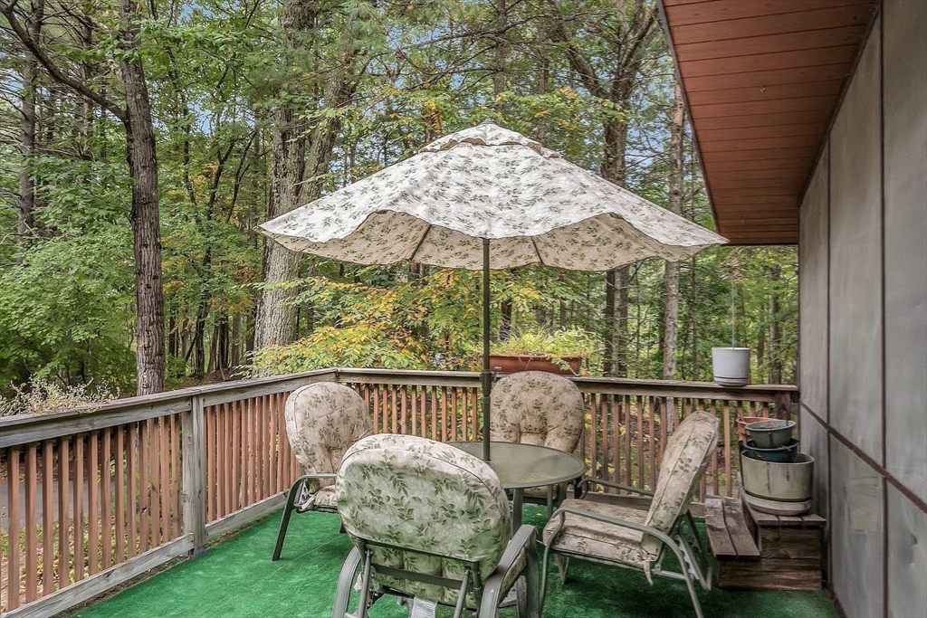 191 Heald Road Carlisle, MA 01741 - Photo 26 of 32 a view of a chair and table on the deck