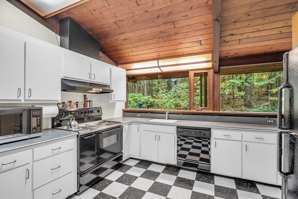 191 Heald Road Carlisle, MA 01741 - Photo 5 of 32 a kitchen with a stove a sink and white cabinets