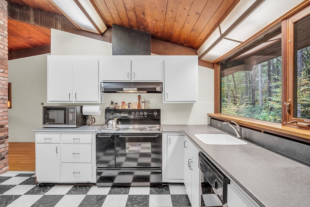 191 Heald Road Carlisle, MA 01741 - Photo 6 of 32 a kitchen with a stove a sink and cabinets