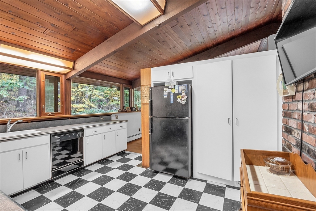 191 Heald Road Carlisle, MA 01741 - Photo 7 of 32 a kitchen with a checkered floor and a refrigerator