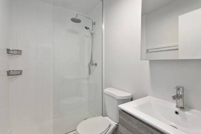 a bathroom with a sink toilet and shower