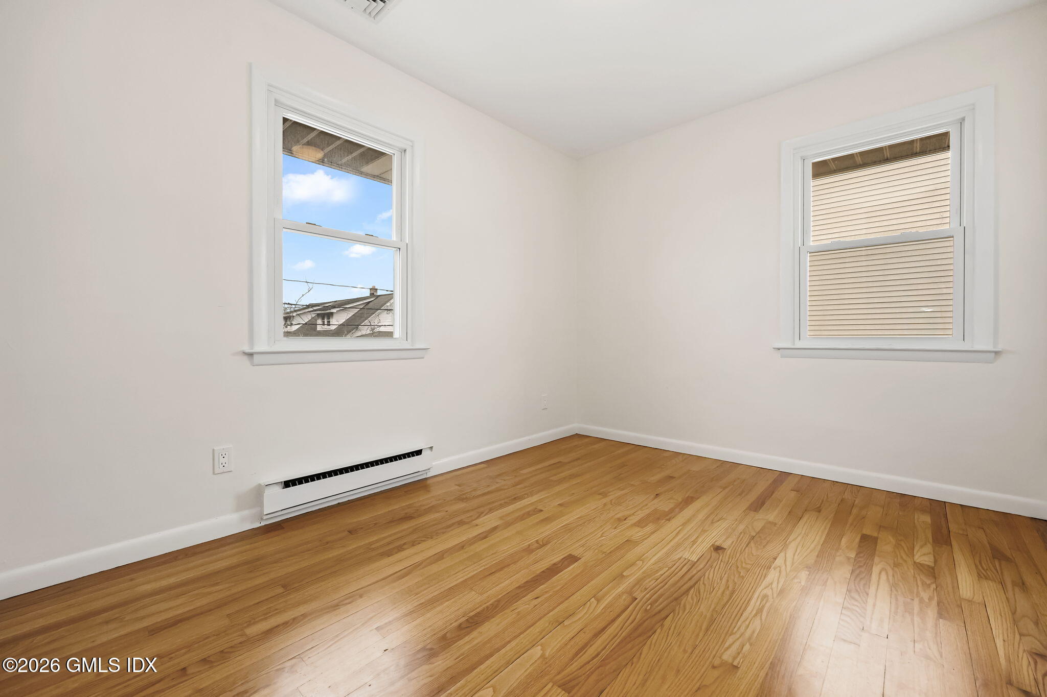 2 Grange Street Greenwich, CT 06830 - Photo 25 of 31 an empty room with wooden floor and windows