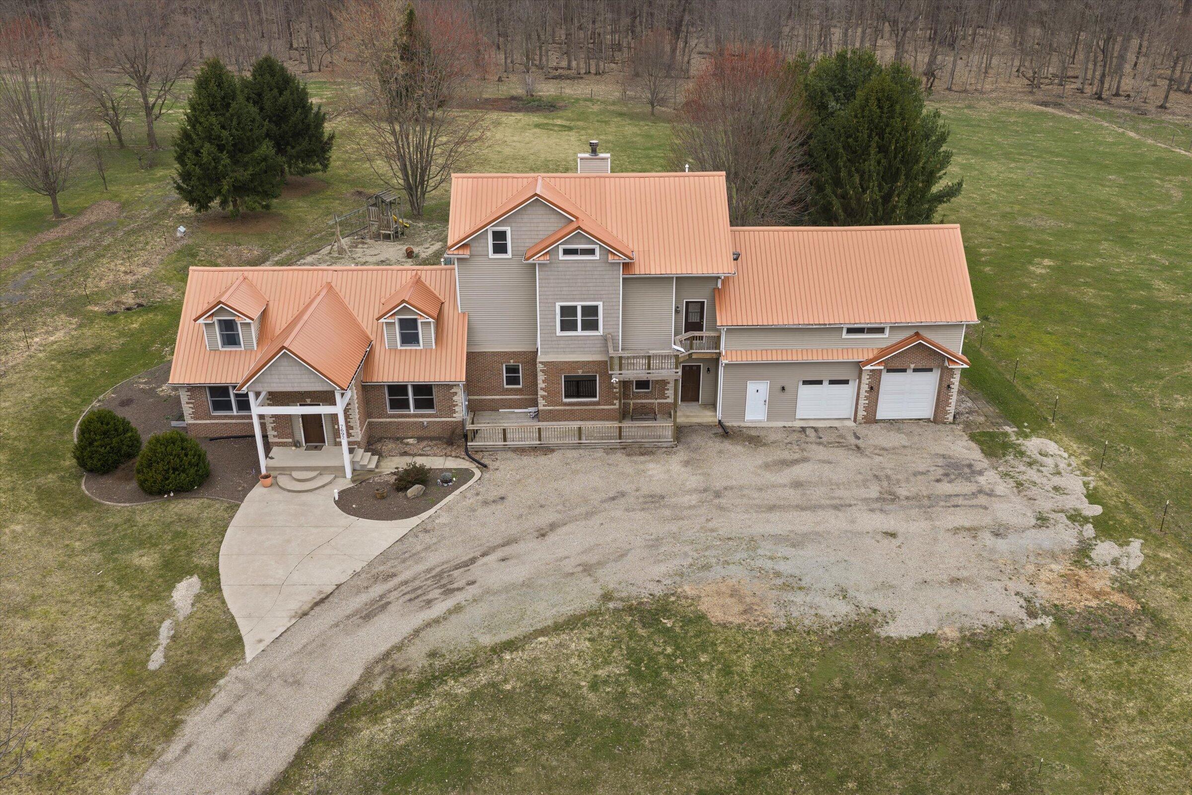 7692 North Emery Road Rolling Prairie, IN 46371 - Photo 56 of 69 an aerial view of a house with swimming pool and patio