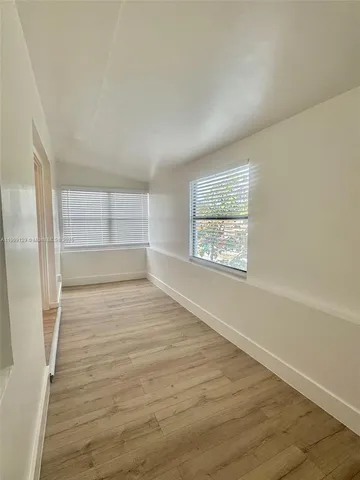 a view of an empty room and wooden floor