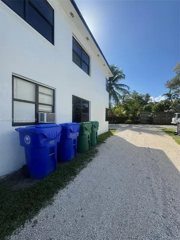 a view of backyard with couches chairs and potted plants